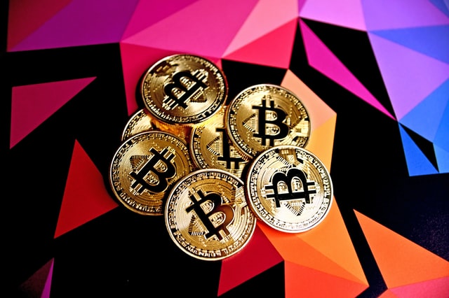 Kryptoměna bitcoin na barevném pozadí